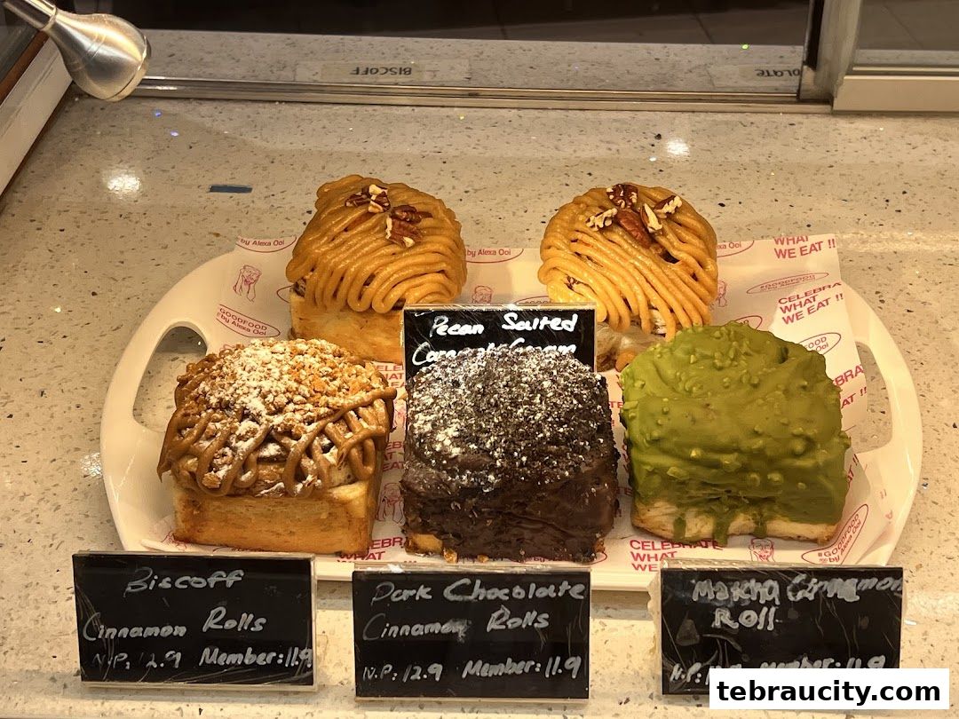 A display of five gourmet cinnamon rolls with various toppings and flavors.