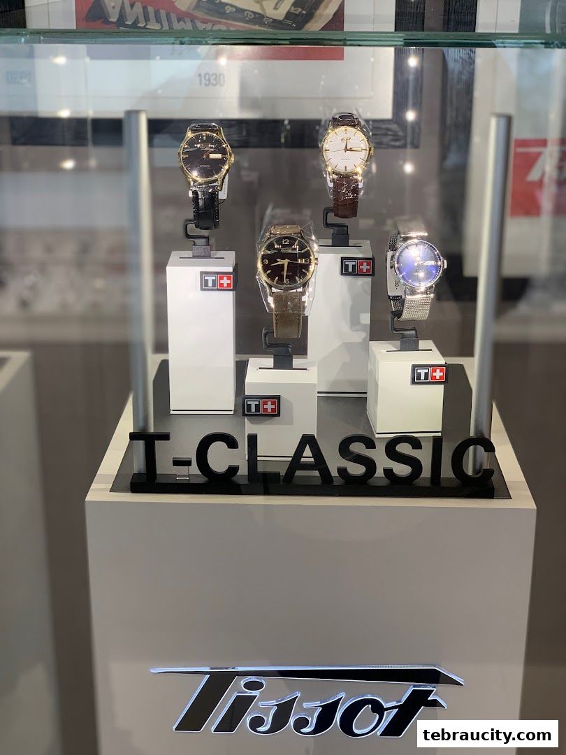 A display case showcasing several Tissot watches, with the brand logo prominently featured.