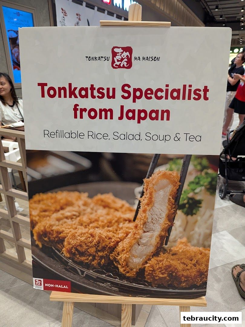 A sign advertising Tonkatsu Specialist from Japan with a picture of tonkatsu.