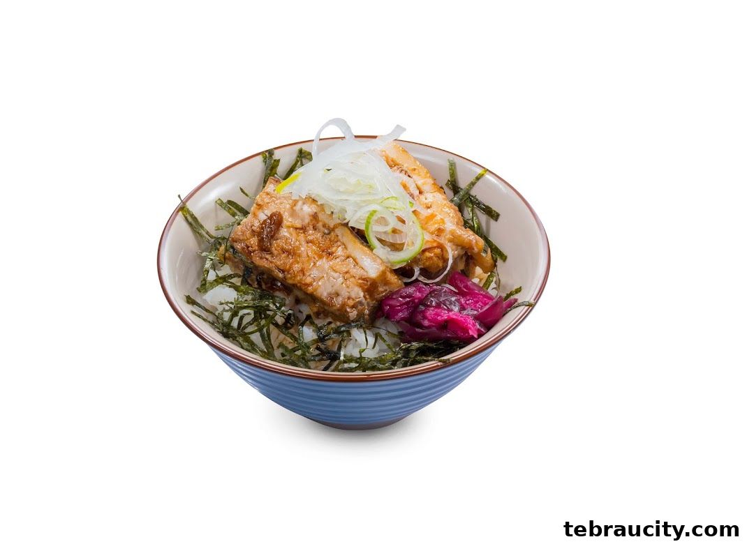 A bowl of rice topped with grilled fish, seaweed, and pickled ginger.