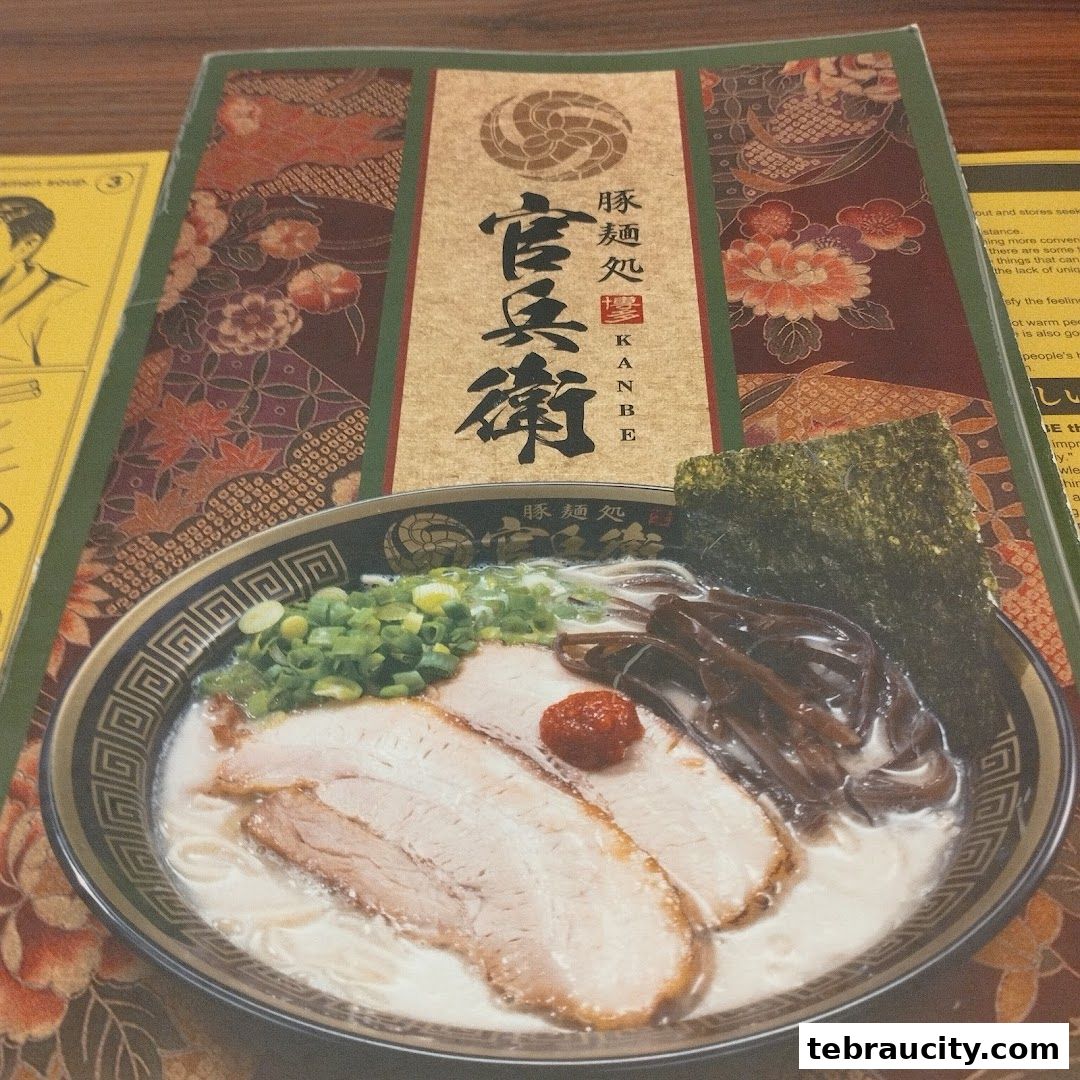A close-up of a ramen menu featuring a bowl of tonkotsu ramen with chashu pork.