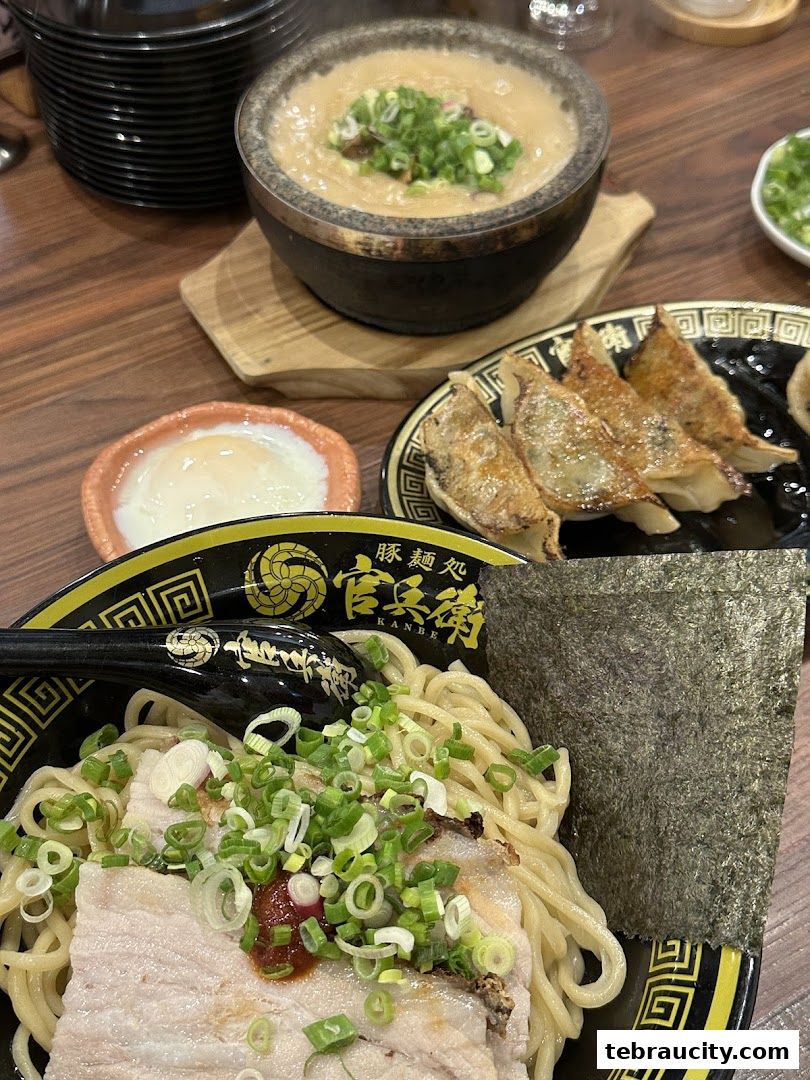 A close-up of a delicious ramen meal with chashu pork, noodles, and gyoza.