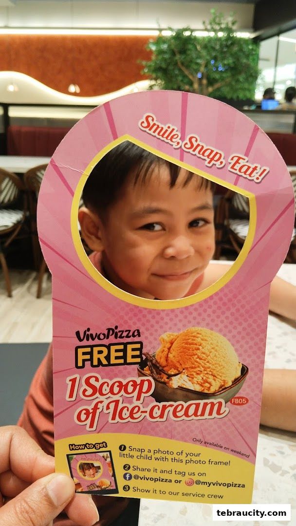 A child is pictured in a promotional frame offering free ice cream from Vivo Pizza.