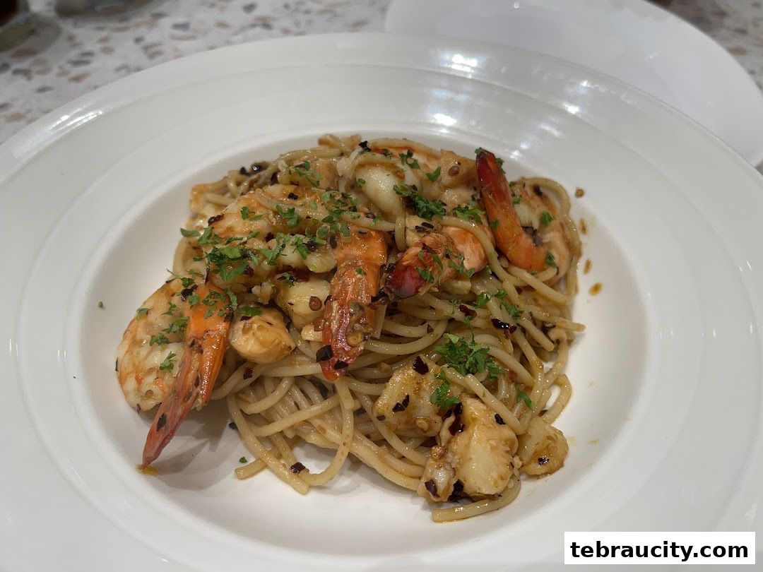 A close-up shot of a delicious seafood pasta dish with shrimp and herbs.