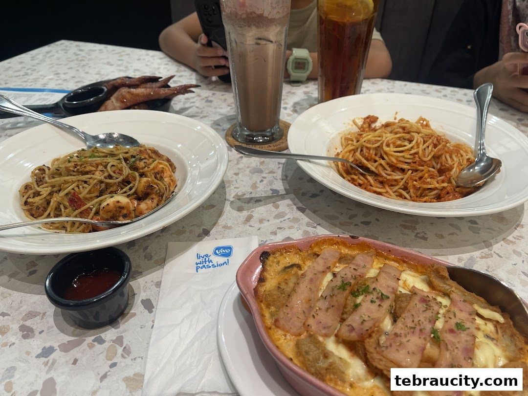 A table laden with delicious Italian dishes, including pasta and baked gratin, with drinks.
