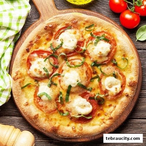 A delicious Margherita pizza with fresh tomatoes and basil on a wooden board.