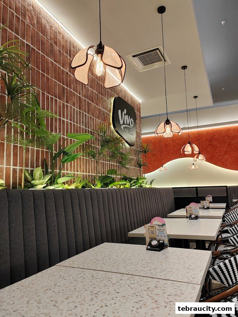 Interior shot of Vivo Pizza with modern decor, plants, and seating.