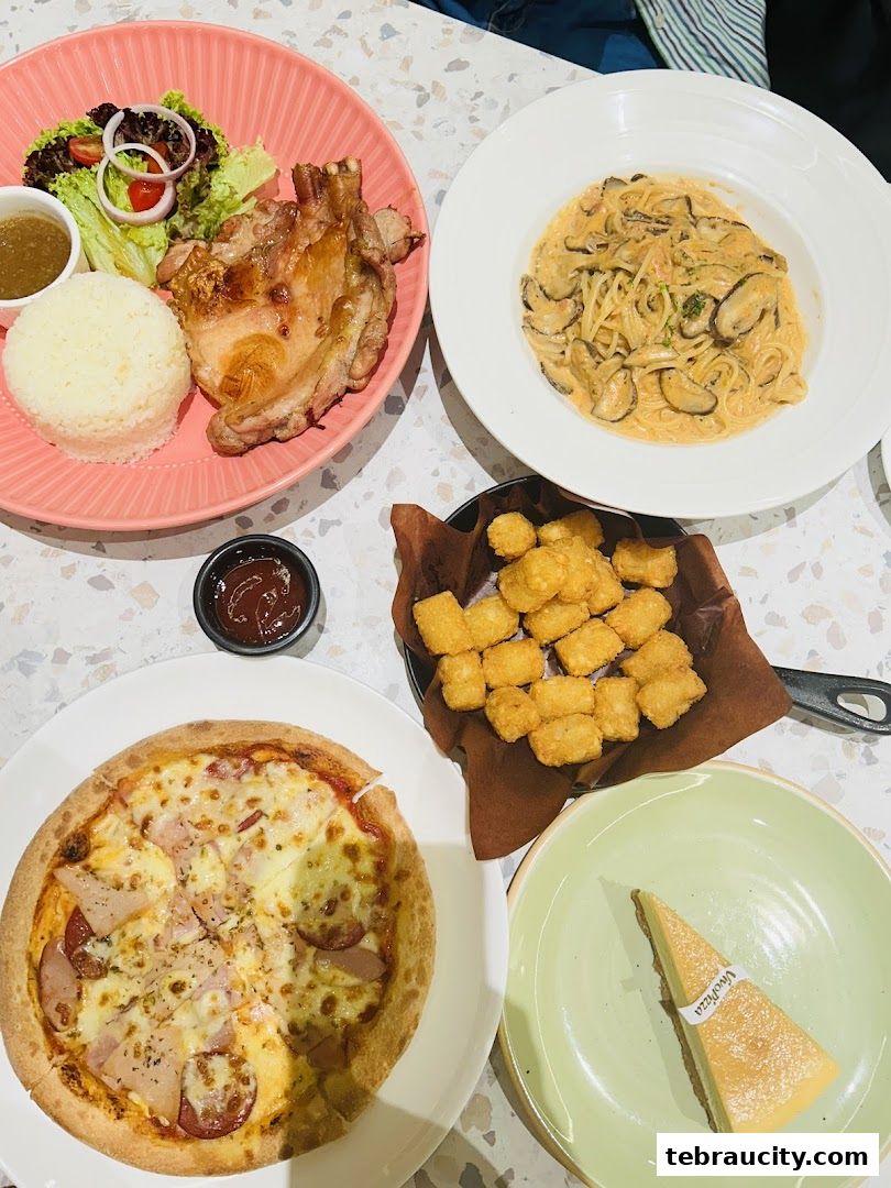 A table laden with various dishes including pizza, pasta, grilled chicken, and a slice of cheesecake.