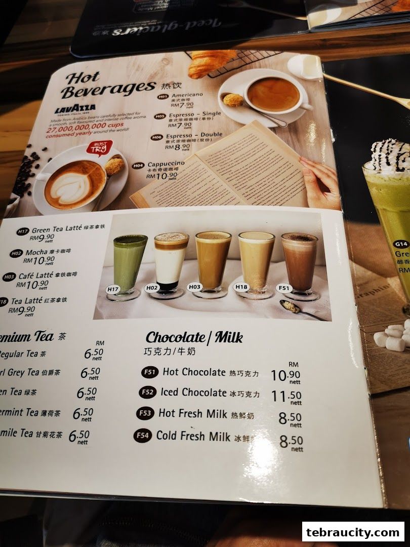 A menu featuring hot beverages, premium teas, and chocolate/milk drinks with prices.