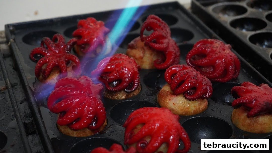 Mini octopuses being cooked with a torch in a special pan.