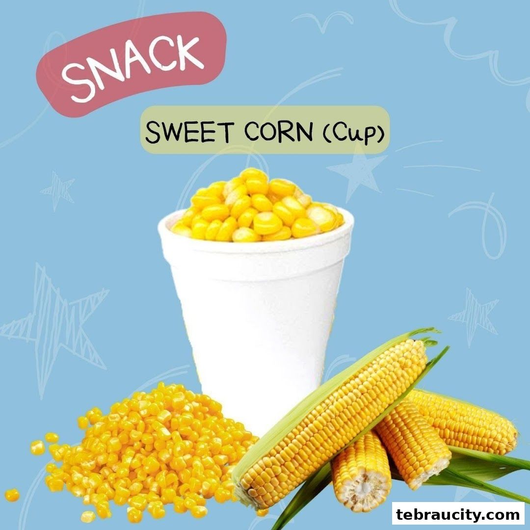 A cup of sweet corn with corn cobs and kernels on a blue background.