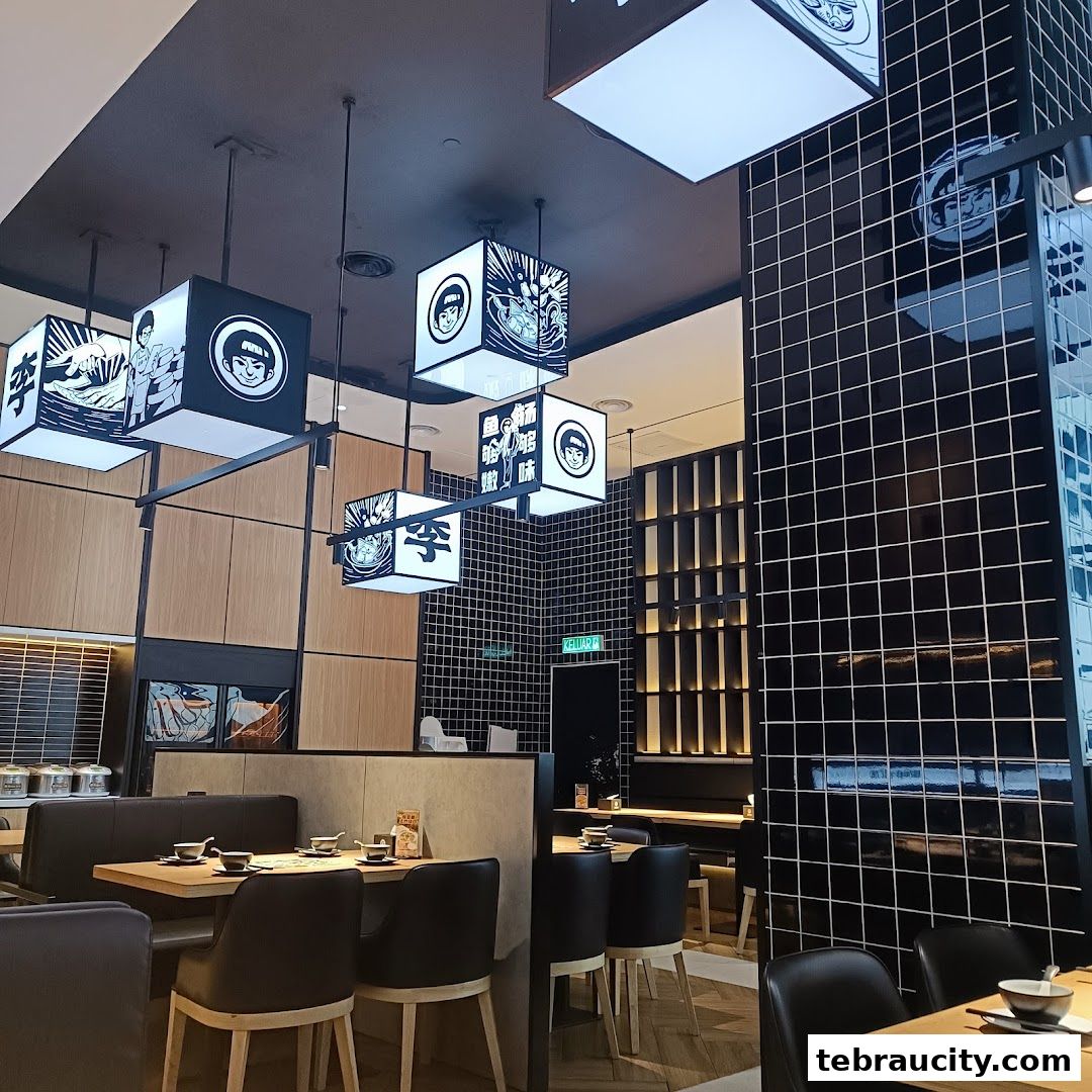 Interior view of a modern restaurant with stylish square pendant lights and comfortable seating.