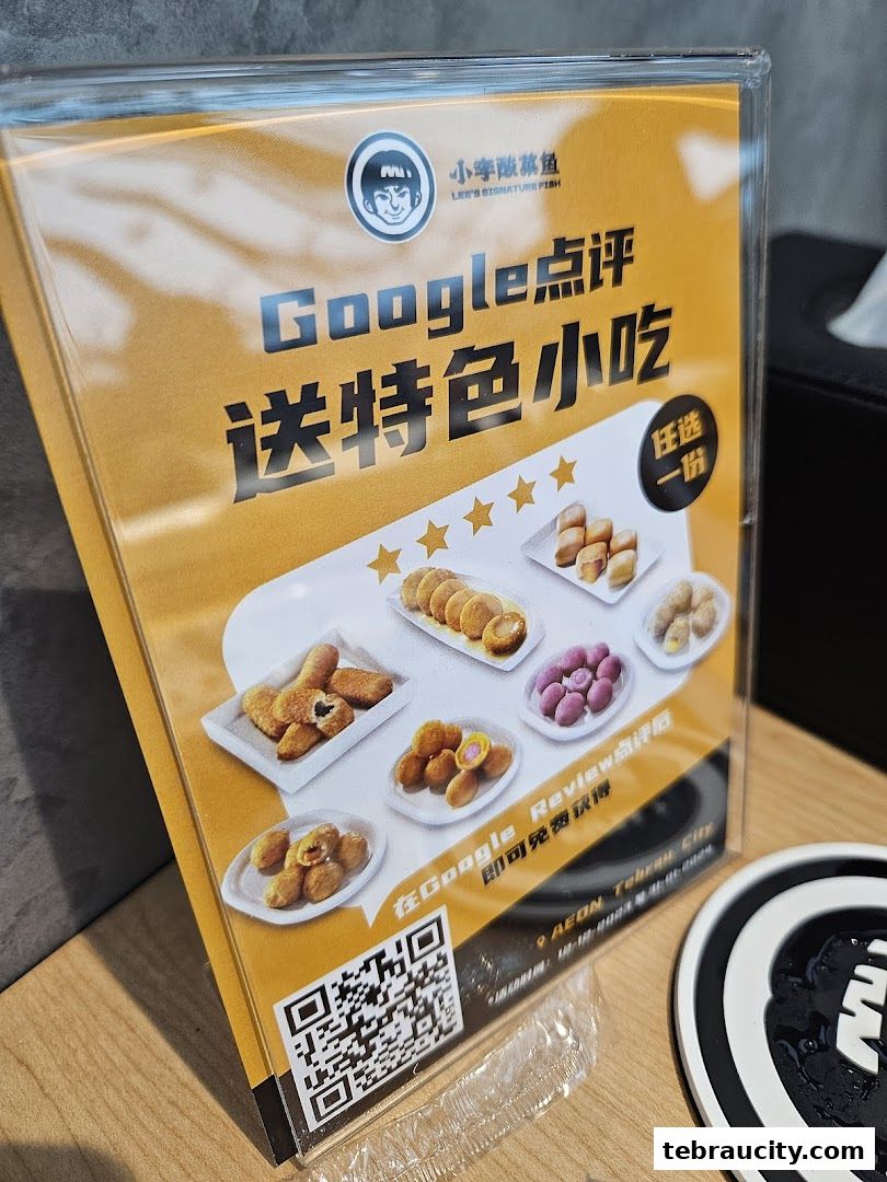 A sign promoting a free snack with a Google review at Lee's Signature Fish.