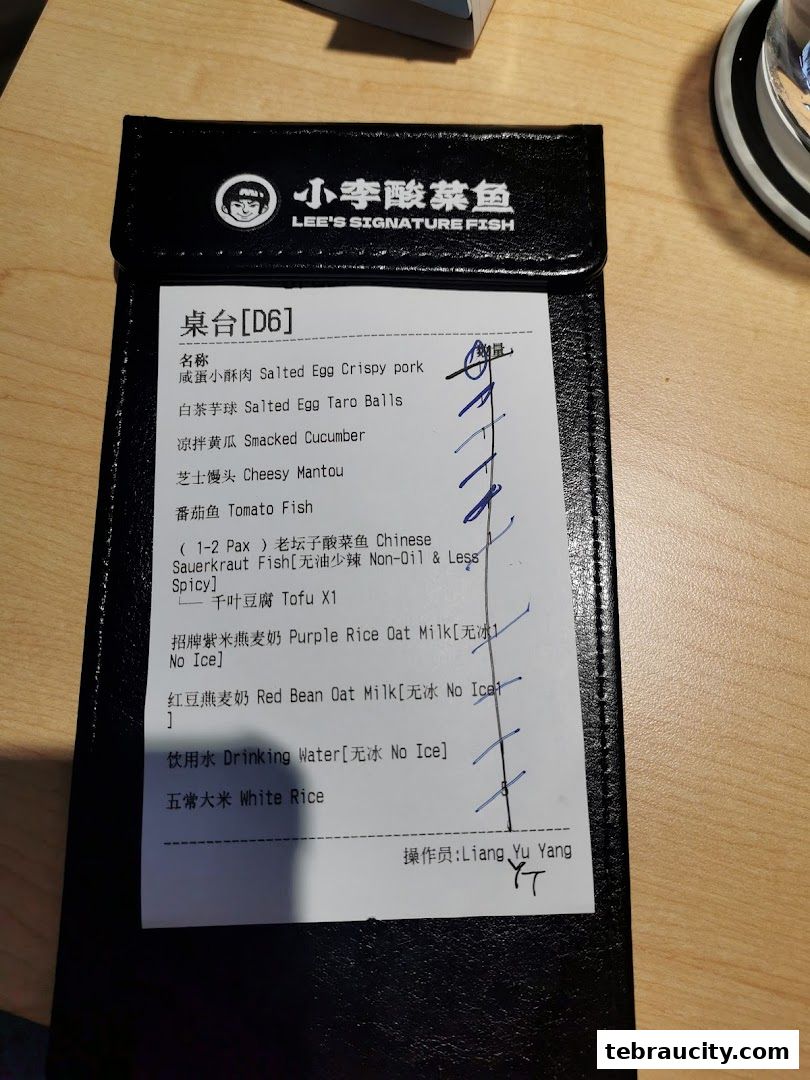 A receipt from Lee's Signature Fish with a list of ordered food and drinks.