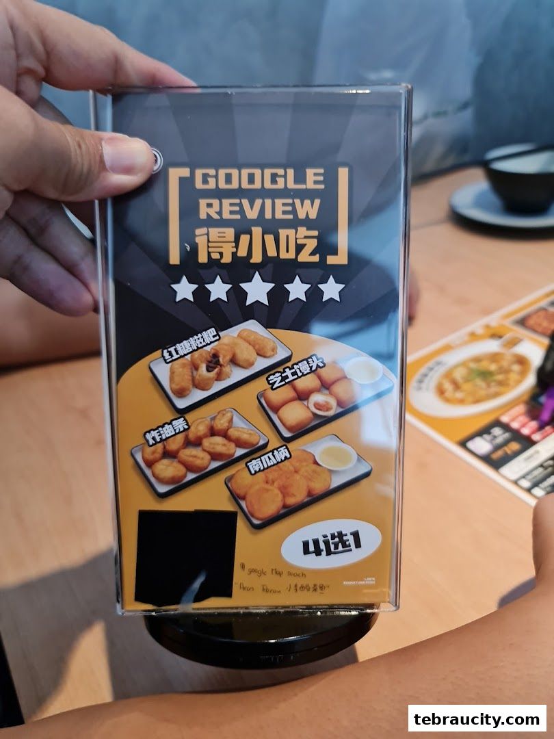 A display board showing four types of fried snacks with Chinese names and a Google review prompt.
