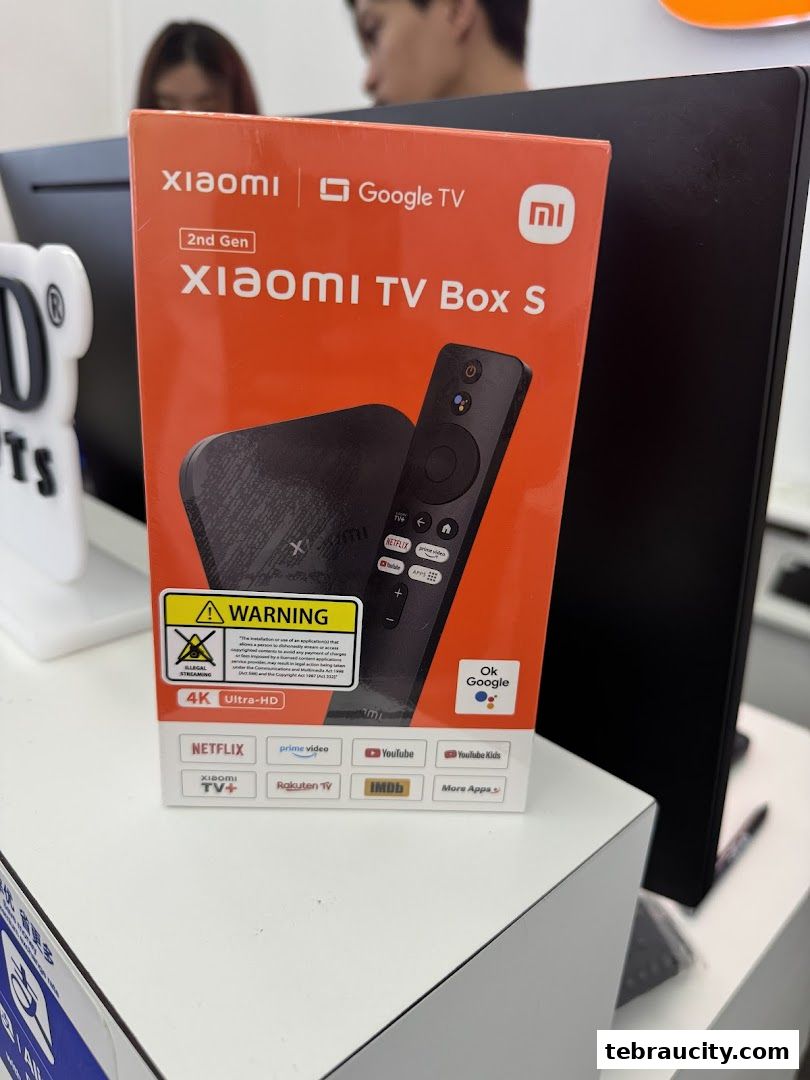 A Xiaomi TV Box S 2nd Gen with remote control and various app logos on its packaging.