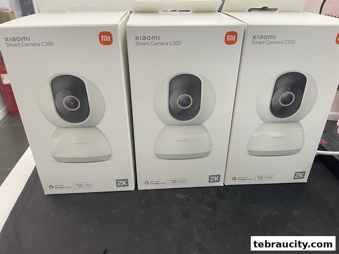 Three boxes of Xiaomi Smart Camera C300 are displayed, highlighting their 2K resolution and smart home compatibility.