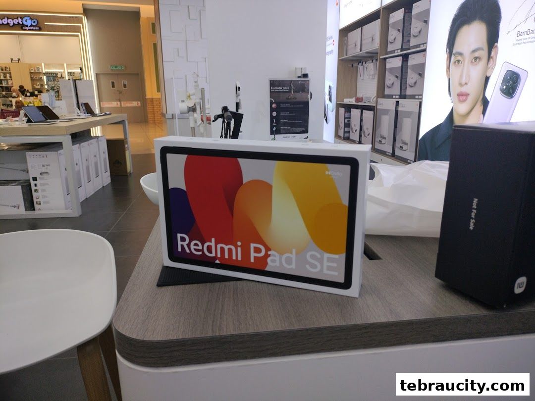 A Xiaomi Redmi Pad SE box is displayed on a counter in a retail store.