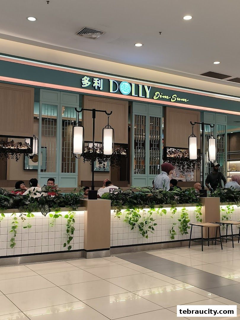 Interior view of Dolly Dim Sum restaurant with customers seated and lush greenery.