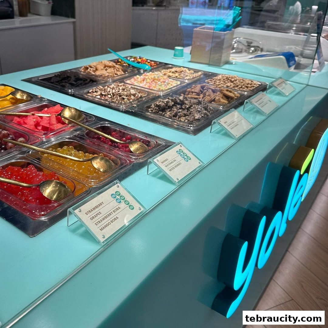 A display of colorful toppings and boba pearls at a Yolé frozen yogurt shop.