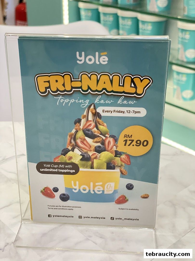 A promotional sign for Yolé's 'Fri-Nally' offer featuring a cup of frozen yogurt with unlimited toppings.