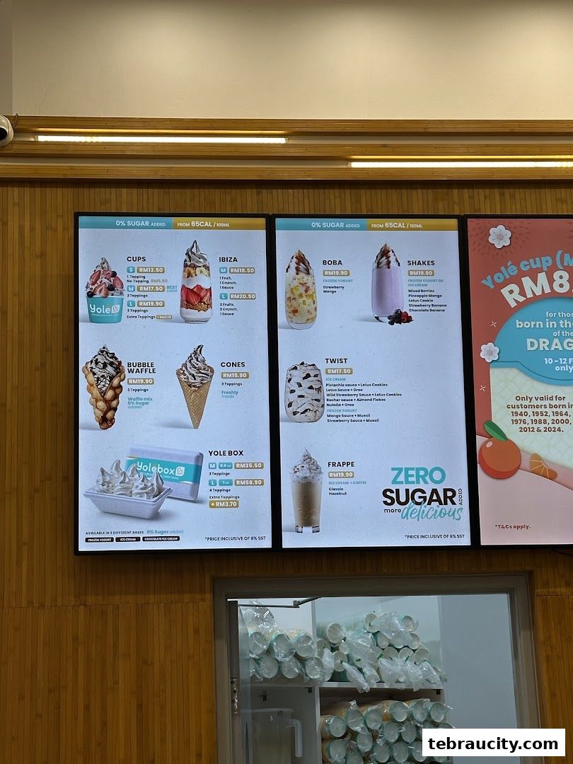 A digital menu board displaying various frozen yogurt and dessert options from Yolé.
