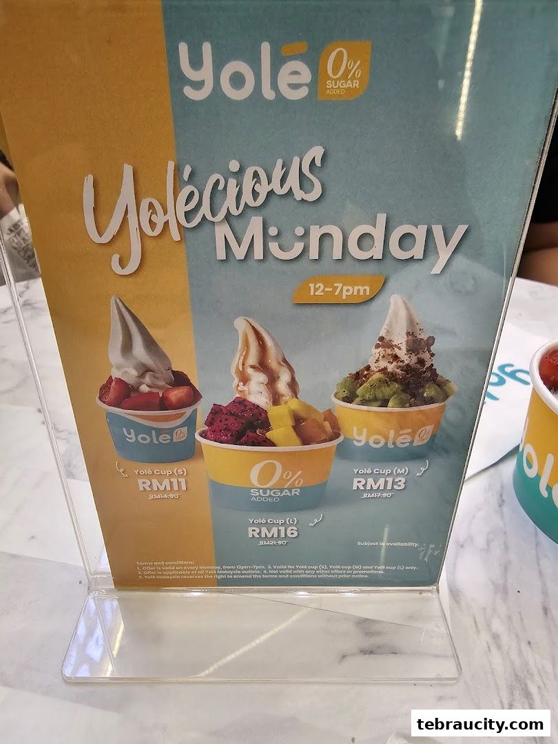 A menu board showcasing Yolé's frozen yogurt cups with fruit toppings and prices.