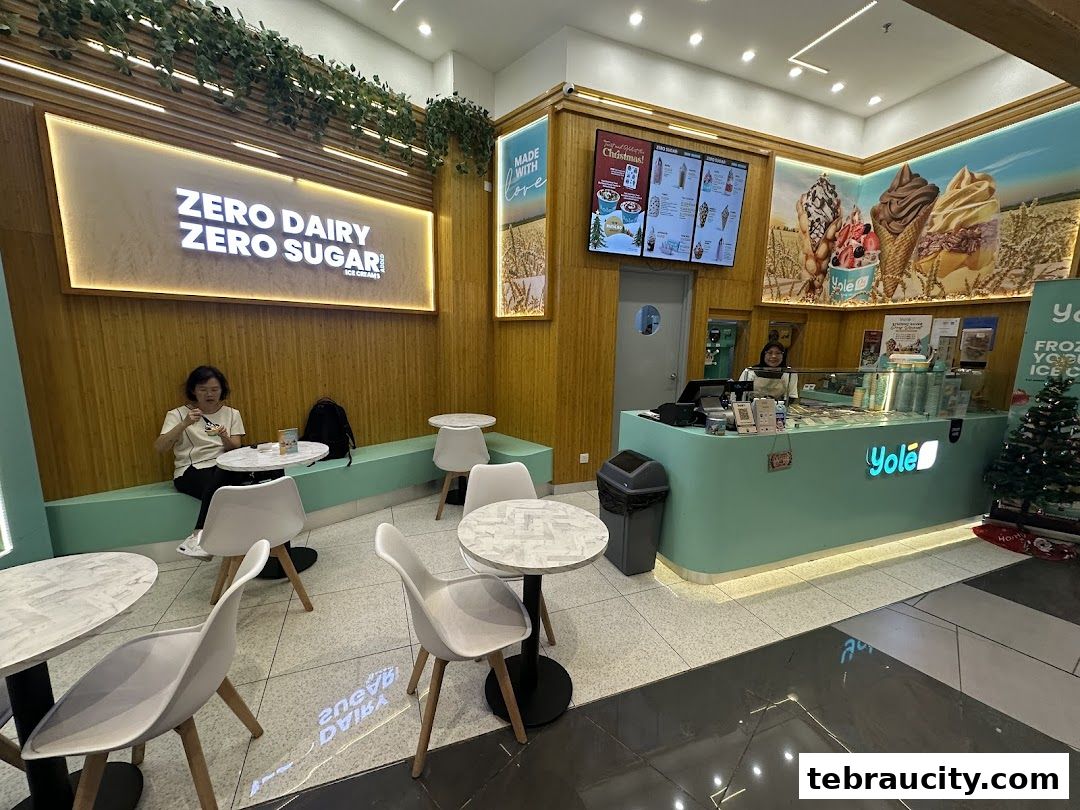 Interior of a Yolé ice cream shop with seating, a counter, and menu displays.