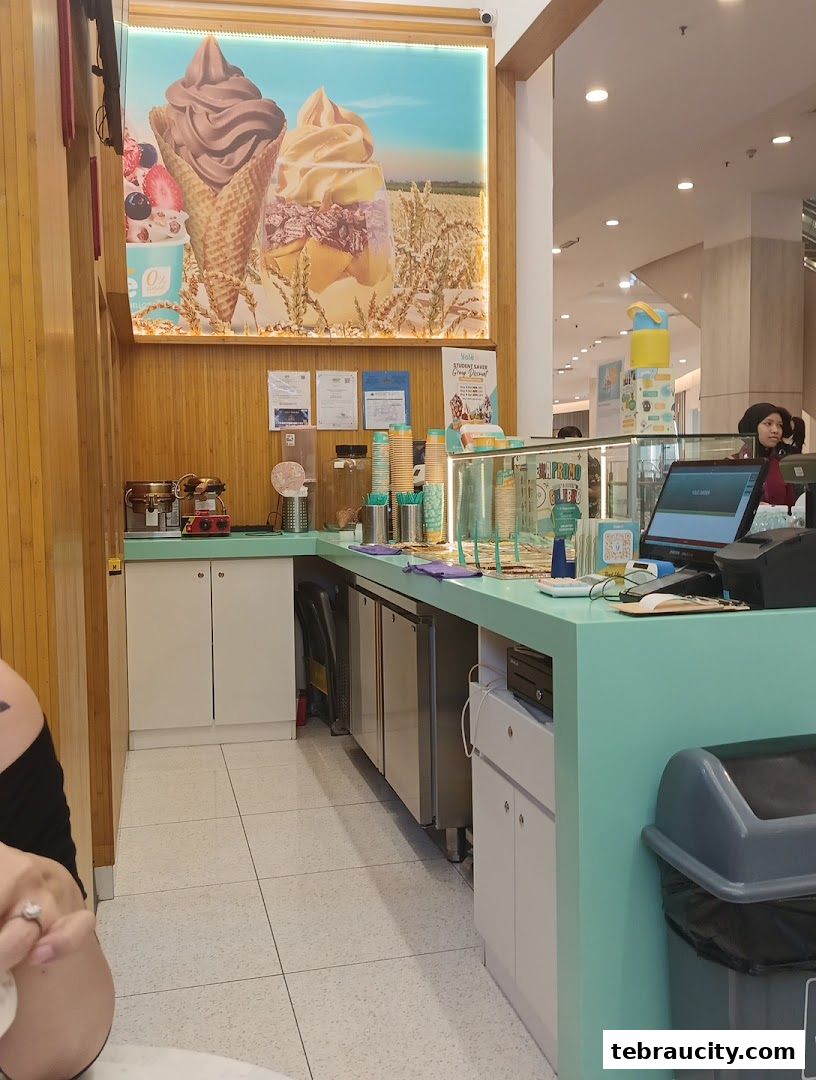 A Yolé ice cream counter with a large promotional image of ice cream cones and cups.