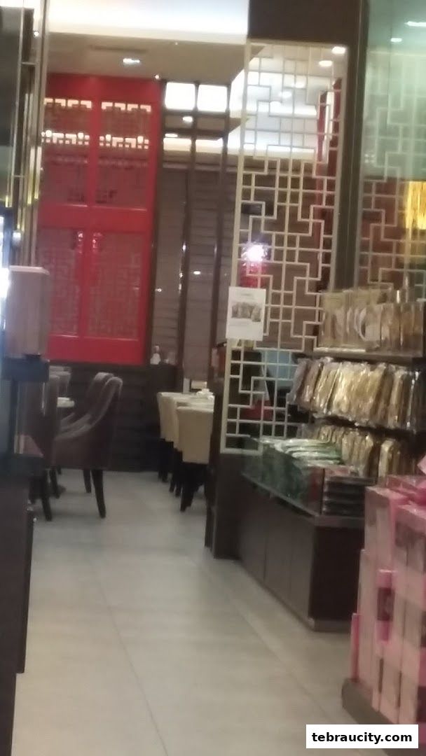 Interior view of a shop with seating, shelves of products, and decorative screens.