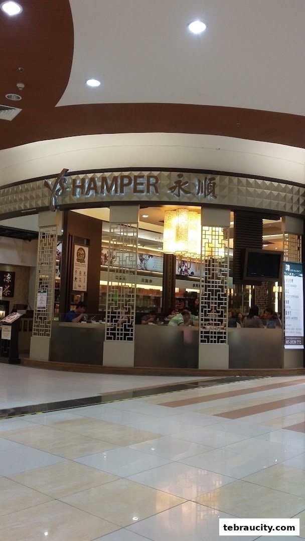 The exterior of YS Hamper, a shop with a modern design and interior seating visible.