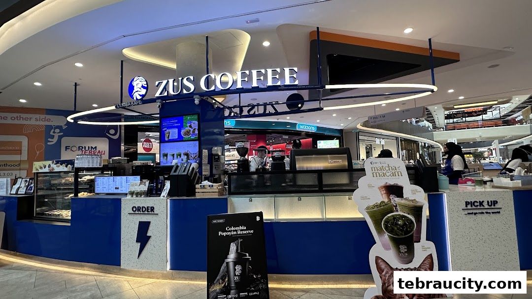 The ZUS Coffee shop front with blue and white branding, displaying menu items and a 'Pick Up' counter.