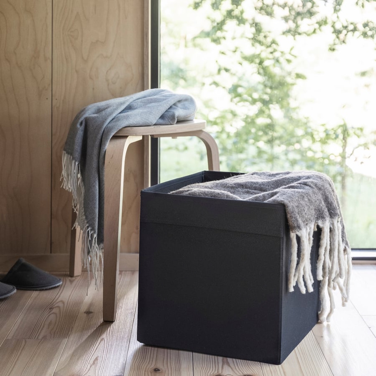 Black DRÖNA fabric storage box on a shelf at IKEA, KALLAX-compatible cube