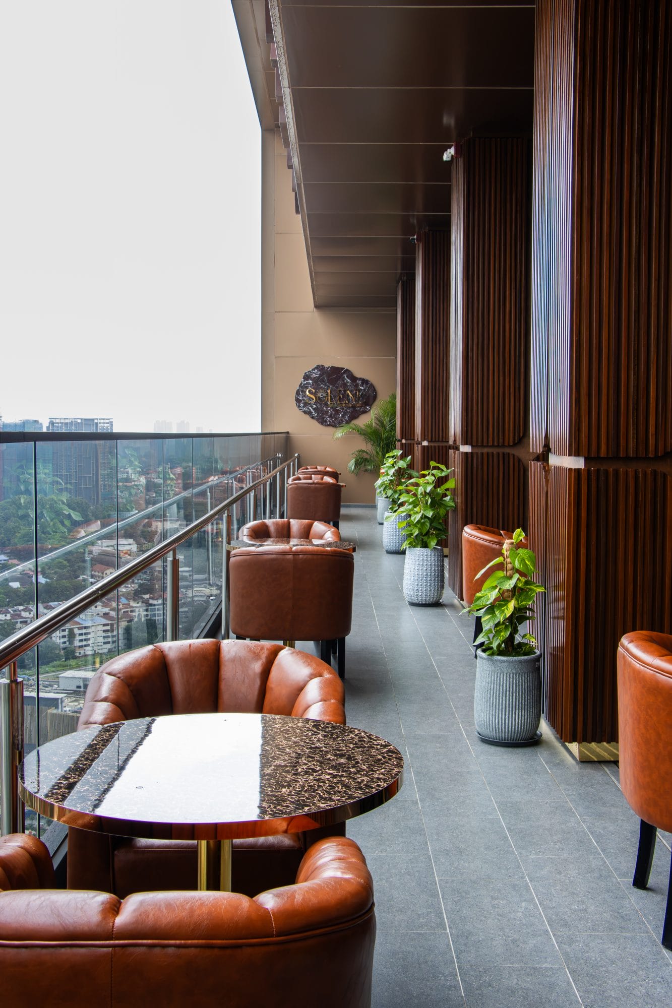 Interior of SOLENE showing the dining room and rooftop terrace at SKS Tower